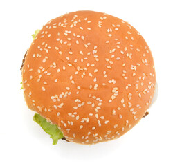 Cheeseburger and Mustard in sesame seeded bun isolated on white from overhead.