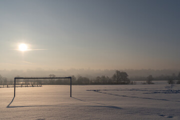An abandoned soccer field covered in snow © Tomasz