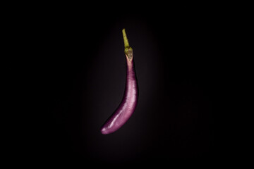 Eggplant isolated floating. Black background. Creative food concept