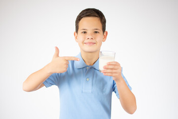 ute boy in blue shirt holding glass of milk on white background