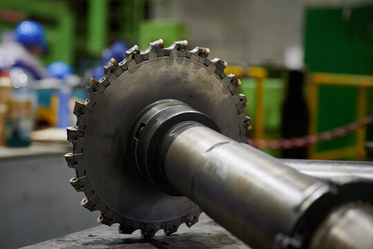 A durable high-quality cutter with a diameter of 315 mm for metal rolling of high-strength carbide alloys lies on the workbench of a turner-milling machine, steel, molybdenum, hard cutters