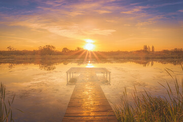 Wooden pier at the river at the autumn sunrise