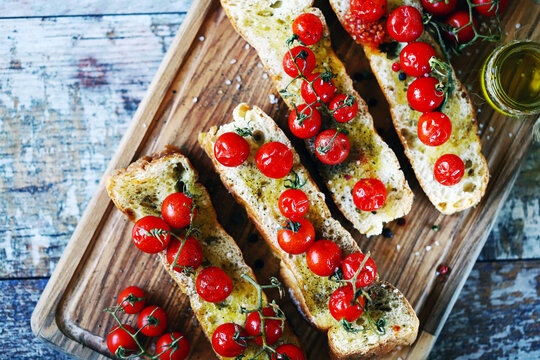 Bruschetta with olive oil and cherry tomatoes. Delicious ciabatta with baked tomatoes.