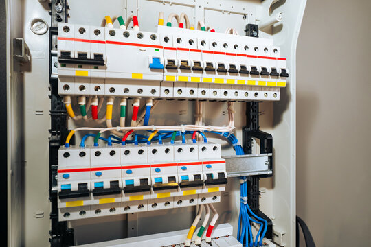 Electrical panel with multi-colored wires. Voltage distributor with circuit breakers. New automated system of electric power supply and distribution. Electric boxes with high-voltage equipment.