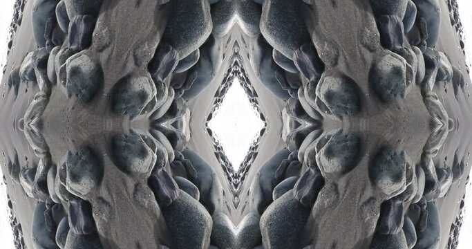Kaleidoscopic sea landscape with stone. Mirror side effect for natural abstract footage