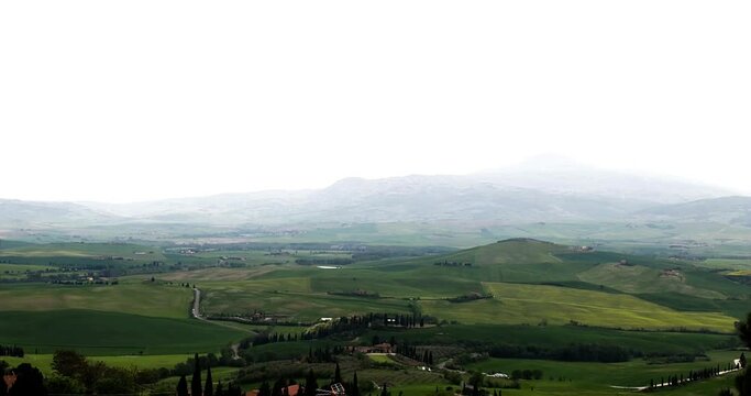 Time lapse tuscany landscape with clouds moving and green fields