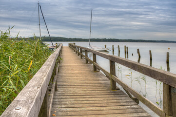 Fototapeta premium Quiet, cloudy morning at the boat dock on lake Ratzeburg.