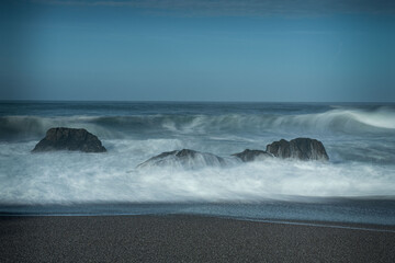 Waves coming towards the beach, long exposure on a blue sky day with no clouds, and lots of copy-space, Schoolhouse Beach in Sonoma County, CA, USA