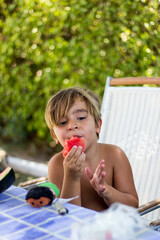 child in the field eating watermelon