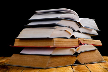 Naklejka premium Pile of open books. A large amount of information contained in books.