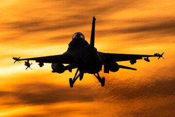 A fighter jet at sunset.