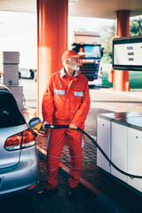 Handsome senior  beard man working on gas station.