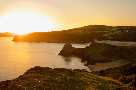 Beautiful Three Cliffs Bay at sunset, the Gower Peninsula, Wales. Beach at sunset with hills. 