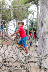 children climbing ropes in a playground
