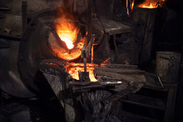 Foundry electric arc furnace with molten liquid iron. Metallurgy and industrial steel production.