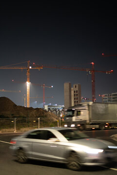 Cars flying by the construction site "Terminal 3" at Europes Centrum Airport Frankfurt am Main.