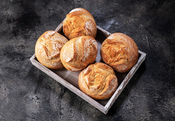 buns in a box on a wooden table