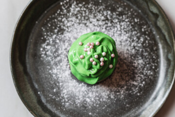 St. Patrick's Day cupcake on a dark plate on the table
