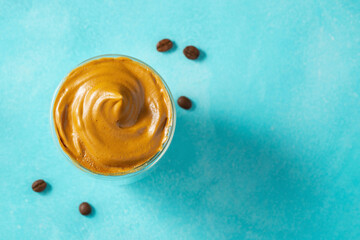 Dalgona coffee. Iced fluffy creamy whipped trend drink with coffee foam and milk. Trendy drink during Covid-19 city lock down and self quarantine, stay at home concept. Top view with copy space