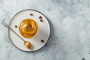 Dalgona coffee. Iced fluffy creamy whipped trend drink with coffee foam and milk. Trendy drink during Covid-19 city lock down and self quarantine, stay at home concept. Top view with copy space