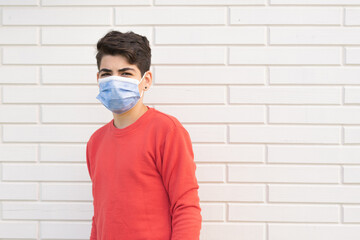 Portrait of a young man using a mask face to protect himself against the coronavirus