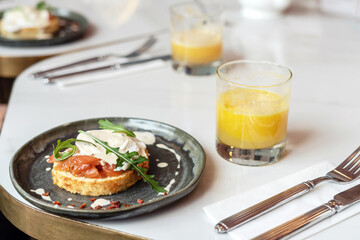 Smoked salmon sandwich with cream cheese on plate close-up