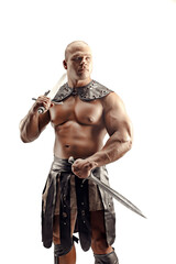 Severe barbarian in leather costume with sword. Portrait of balded muscular gladiator. Studio shot....