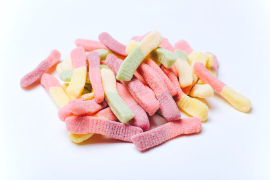 Pile of colorful pastel gummy candies on white background