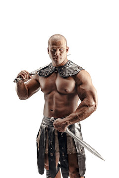 Severe barbarian in leather costume with sword. Portrait of balded muscular gladiator. Studio shot. Isolated on white background.