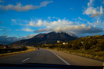 View from the passenger seat of a car, driving in the American SouthWest.