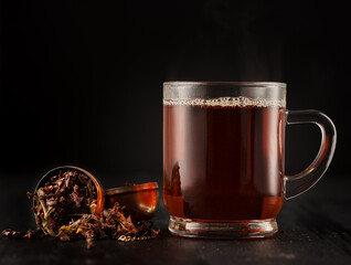 Glass mug with black tea
