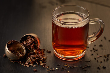 Glass mug with black tea