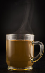 Chamomile tea on black background