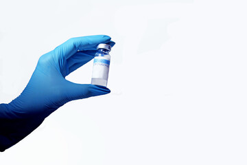 a hand in a blue glove holds the covid-19 vaccine, for vaccinating people on a white background, isolate