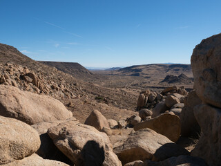 Fototapeta na wymiar Colorful panorama of boulders, desert scenery, mountains at sunset in Yucca Valley, California near Joshua Tree National Park
