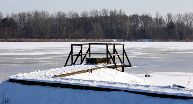 Pier on a frozen river in Poland, Serock
