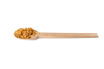 Crispy carmelized fried onion flakes in wooden spoon isolated on white background. Spices and food ingredients.