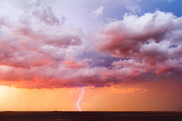 Storm clouds and lightning at sunset