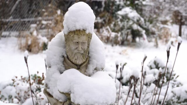 Garden Statue Saint covered in Snow