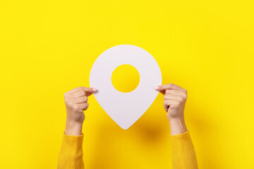white map pointer 3d pin  in hand over yellow background
