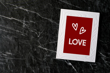 Happy valentine’s day concept, Love you word, heart shape, on white vintage wooden frame standing on white wall with shadow and copy space for text