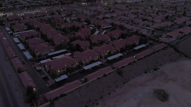 Aerial of suburban neighborhood with mountains in background