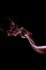 Colorful smoke abstract against black background