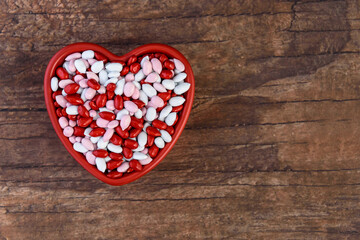 Candy coated sunflower seeds, red, pink, and white, in a heart shaped ceramic dish, Happy Valentines Day
