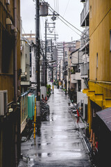 Fototapeta na wymiar Old street alley with wires in a rainy day at Osaka, Japan