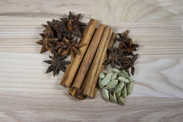 Various spices on a wooden board.