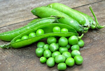 Fresh green peas on wooden background