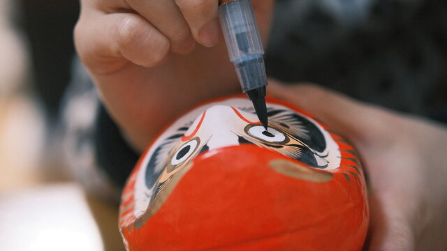 traditional japanese daruma eye being painted