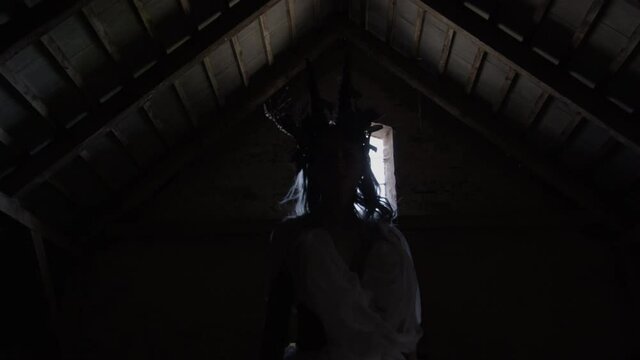 Woman Dressed In Goat Horns And White Dress Rising