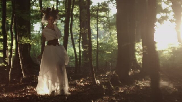 Woman Dressed In White Dress And Goat Horn Headdress